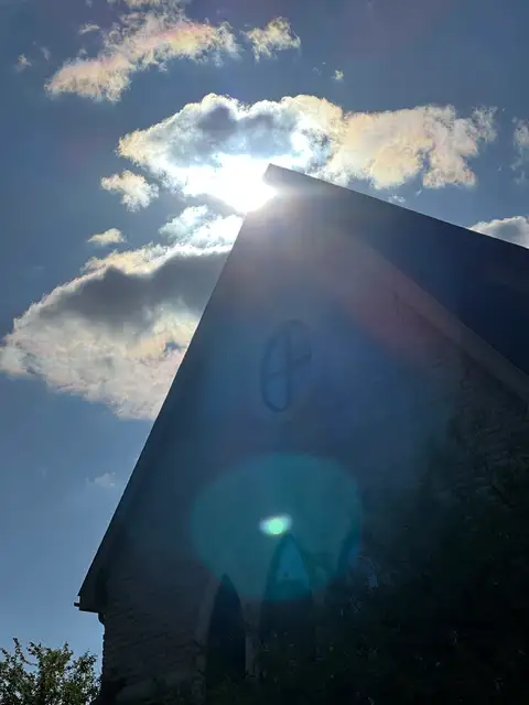 Dazzling sunburst paints the sky and structure.